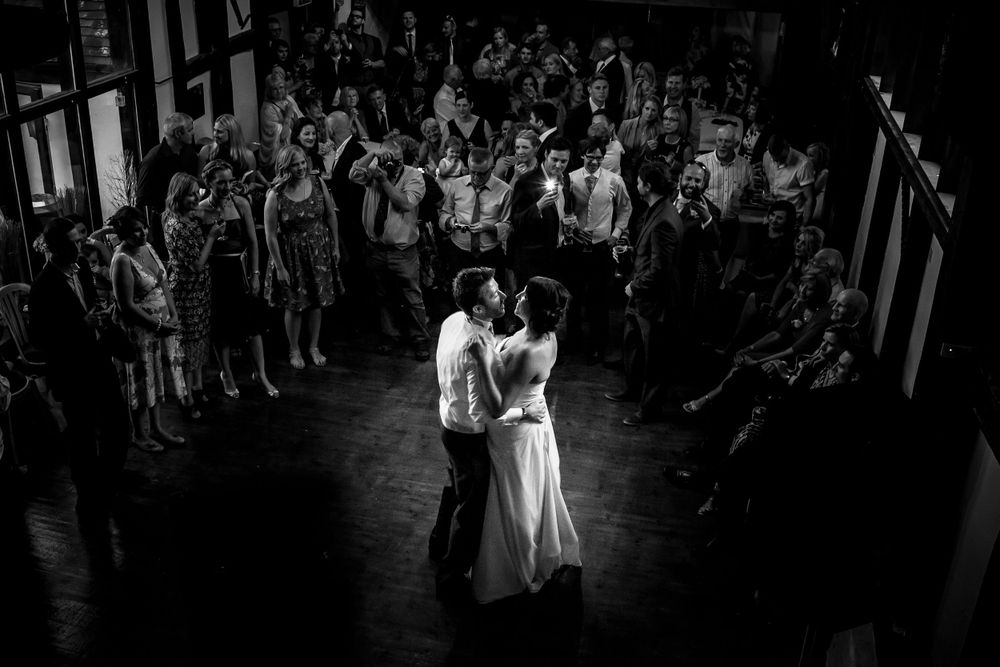 The Bride and Groom take their first dance, watched by by friends and family who form a circle round them